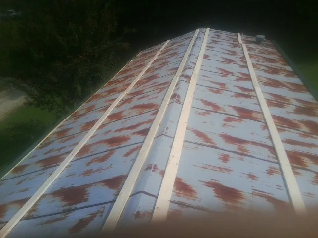 Rusted metal roof panels with new wood purlins before replacement — Storm Damage Roof Repair in Lafferty by Roofing Brothers